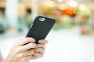 Woman sending sms on cellphone